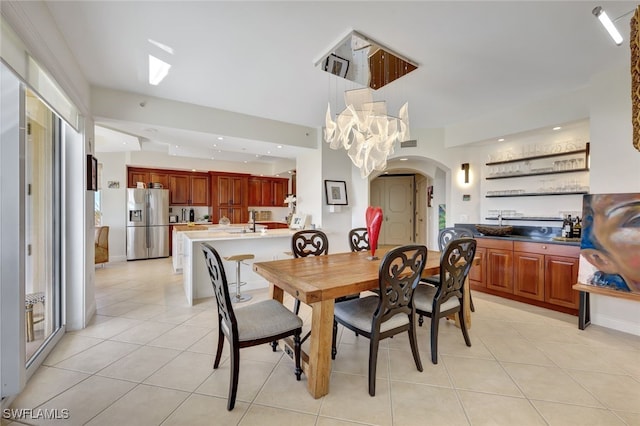 tiled dining room featuring a chandelier