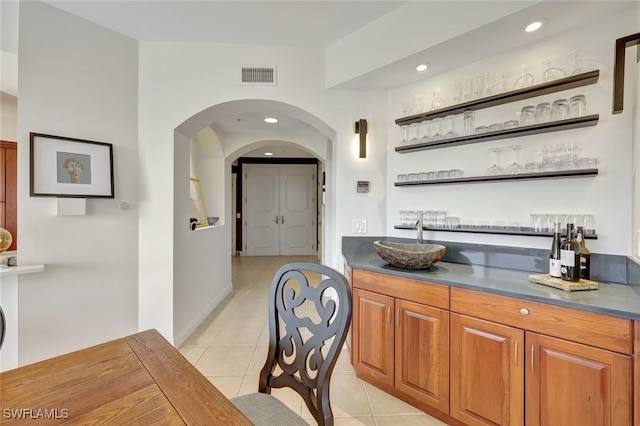 6081 Silver King Blvd Unit 206, Cape Coral, FL 33914 - bar featuring indoor bar, arched walkways, visible vents, and light tile patterned floors