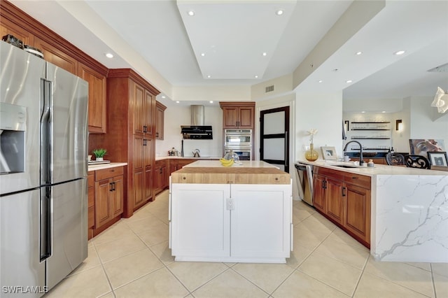 kitchen with a center island, sink, stainless steel appliances, backsplash, and light tile patterned flooring