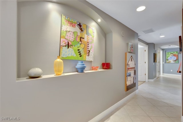 6081 Silver King Blvd Unit 206, Cape Coral, FL 33914 - hall featuring arched walkways, recessed lighting, baseboards, light tile patterned floors, and visible vents