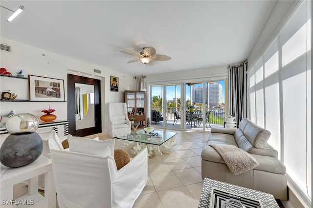 living room with ceiling fan and light tile patterned floors