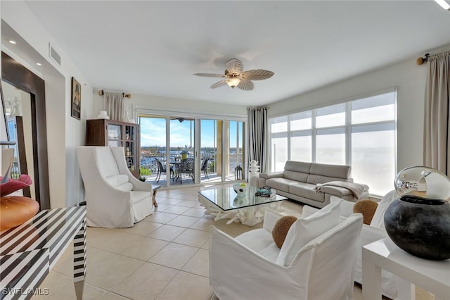 tiled living room with ceiling fan