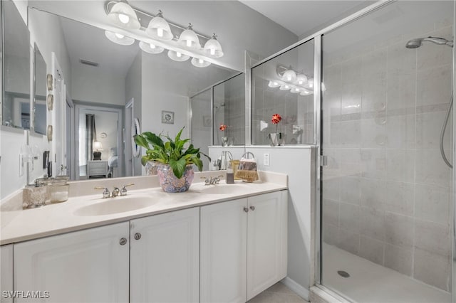 bathroom with vanity and a shower with door