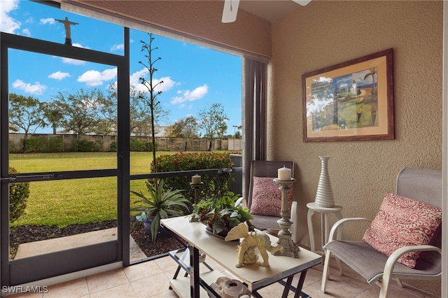 sunroom featuring ceiling fan