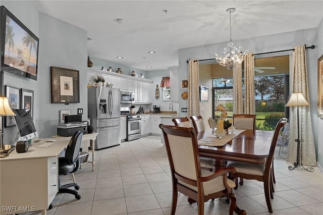 dining area with sink, a chandelier, and light tile patterned flooring