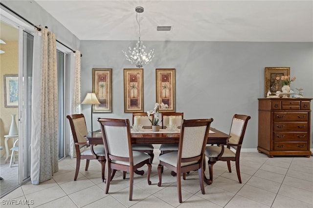 dining room featuring a notable chandelier and light tile patterned floors