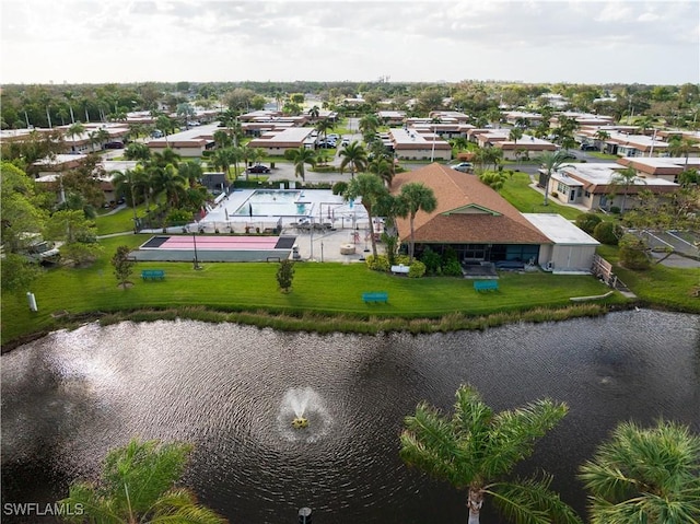 birds eye view of property with a water view and a residential view