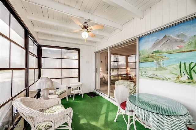 sunroom / solarium featuring beam ceiling and ceiling fan