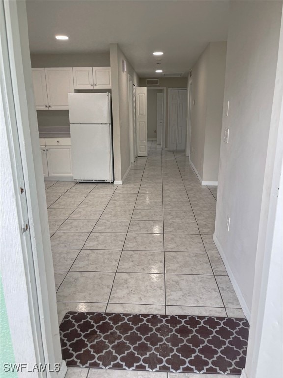 corridor with light tile patterned floors