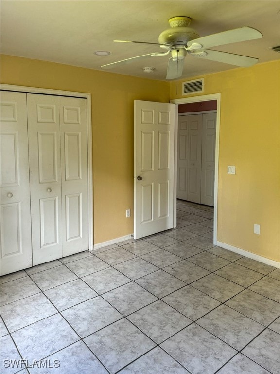 unfurnished bedroom with a closet, ceiling fan, and light tile patterned flooring