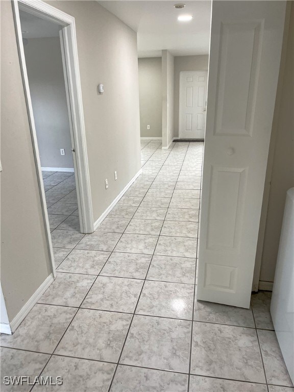 hall featuring light tile patterned floors