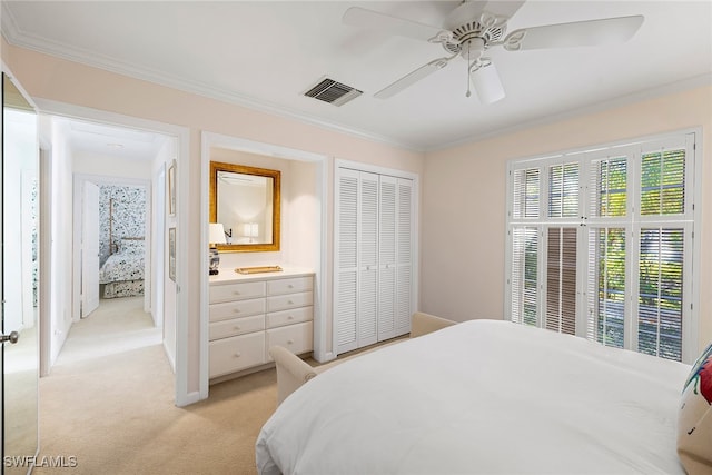 carpeted bedroom featuring connected bathroom, a closet, ceiling fan, and ornamental molding