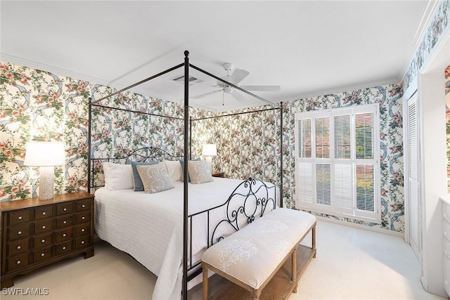 3323 Gin Ln, Naples, FL 34102 - carpeted bedroom with wallpapered walls, ceiling fan, and a closet