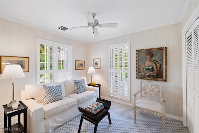 carpeted living room with ceiling fan and ornamental molding