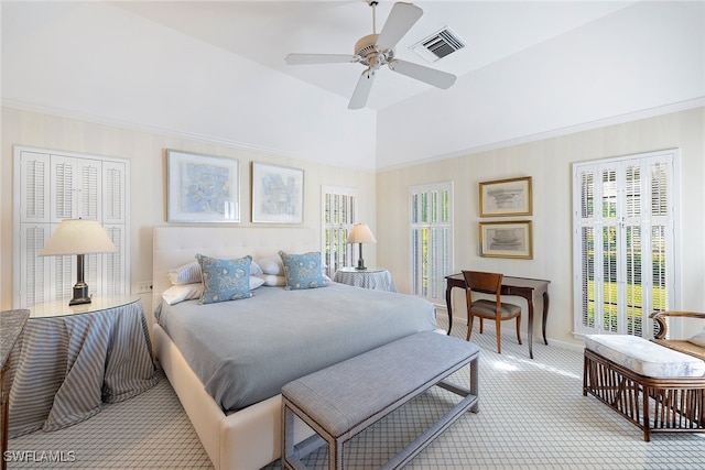 carpeted bedroom featuring ceiling fan and a high ceiling