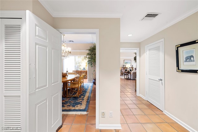 corridor featuring a chandelier, light tile patterned floors, and crown molding