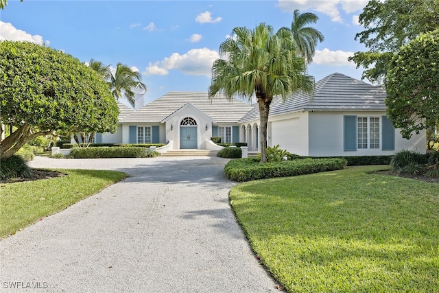 view of front of property with a garage and a front lawn