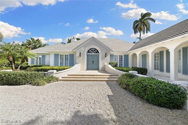 3323 Gin Ln, Naples, FL 34102 - view of front of home featuring stucco siding and a tiled roof