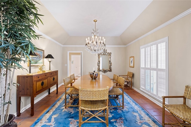 dining room featuring a notable chandelier, dark tile patterned floors, crown molding, and lofted ceiling