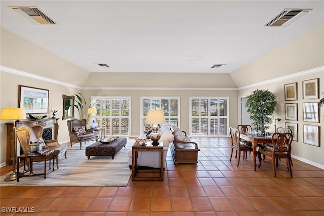 tiled living room featuring vaulted ceiling and a wealth of natural light