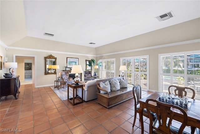 living room with tile patterned floors and crown molding