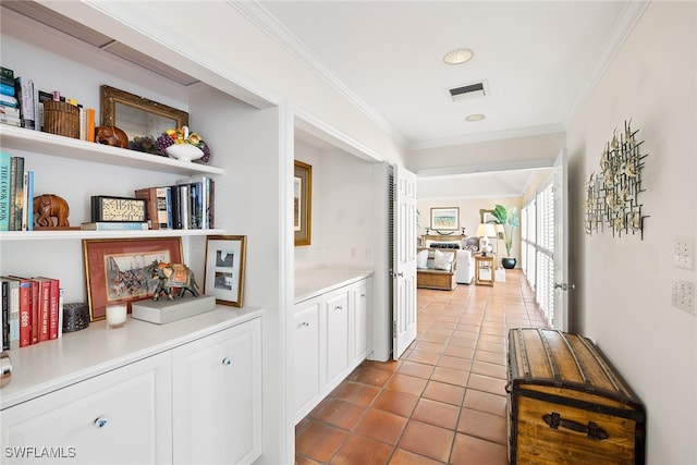 hall with light tile patterned flooring and ornamental molding