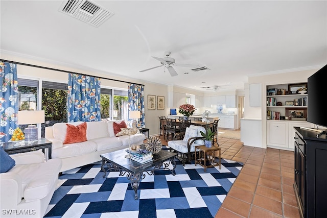 tiled living room featuring ceiling fan and ornamental molding