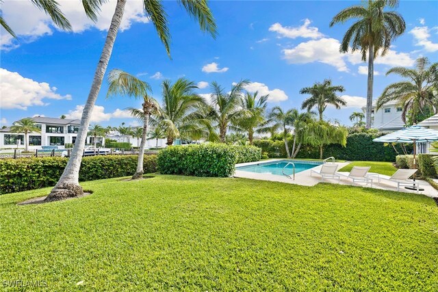 view of yard with a fenced in pool