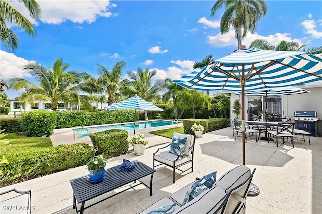 3323 Gin Ln, Naples, FL 34102 - view of patio / terrace featuring an outdoor pool, area for grilling, an outdoor hangout area, and outdoor dining space