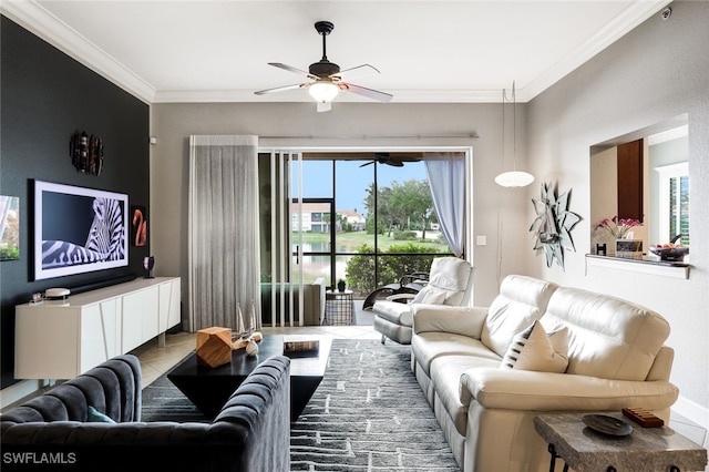 living room with ceiling fan, plenty of natural light, tile patterned flooring, and crown molding