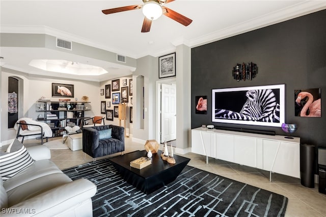 tiled living room featuring ceiling fan and crown molding