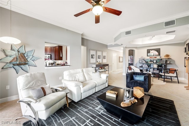 tiled living room with ornamental molding and ceiling fan