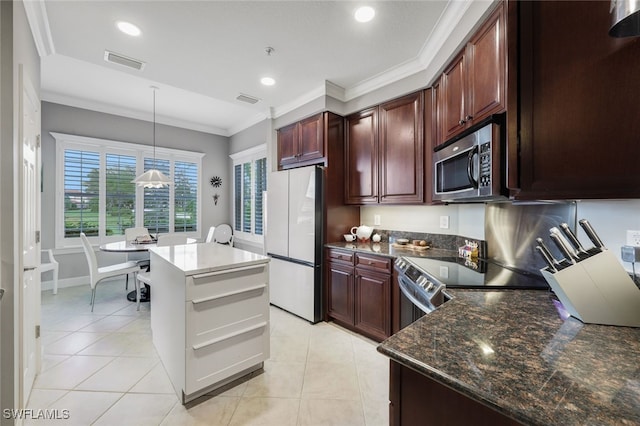 kitchen with crown molding, stainless steel appliances, light tile patterned floors, and decorative light fixtures