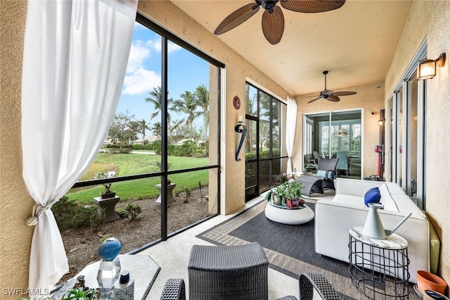 sunroom / solarium featuring a wealth of natural light and ceiling fan