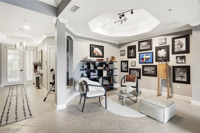 living area with light tile patterned floors, visible vents, a tray ceiling, and ornamental molding