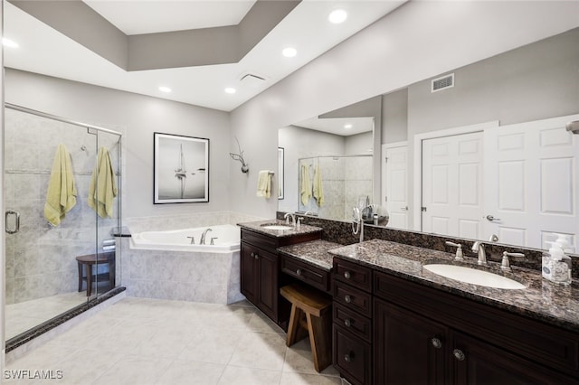 bathroom featuring tile patterned flooring, vanity, and plus walk in shower