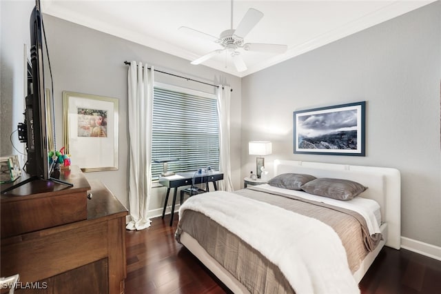 bedroom featuring dark wood-type flooring, ornamental molding, and ceiling fan