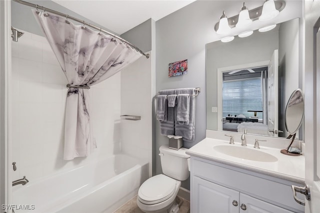 full bathroom with toilet, shower / bath combination with curtain, vanity, and ensuite bathroom