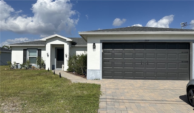 ranch-style home with a garage and a front lawn