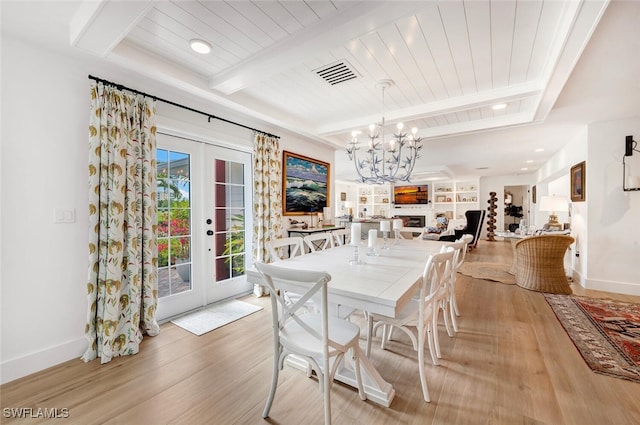 dining room featuring french doors, beamed ceiling, wooden ceiling, a notable chandelier, and light wood-type flooring