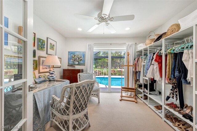 interior space with carpet floors and ceiling fan