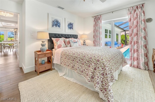 bedroom featuring light hardwood / wood-style flooring, access to outside, and ceiling fan