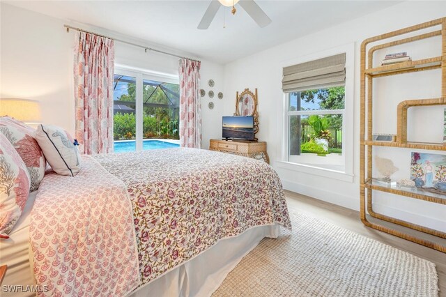 bedroom featuring access to exterior, wood-type flooring, and ceiling fan