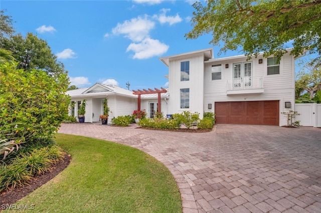 view of front of house featuring a garage and a front lawn