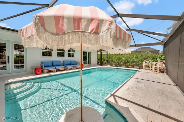 view of swimming pool with a patio and a lanai