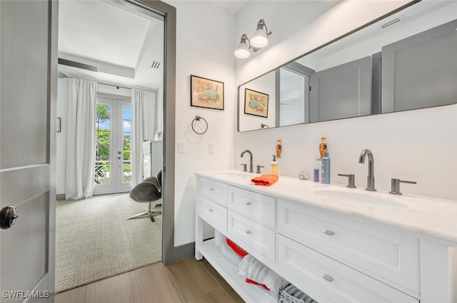 bathroom with vanity, french doors, and hardwood / wood-style floors