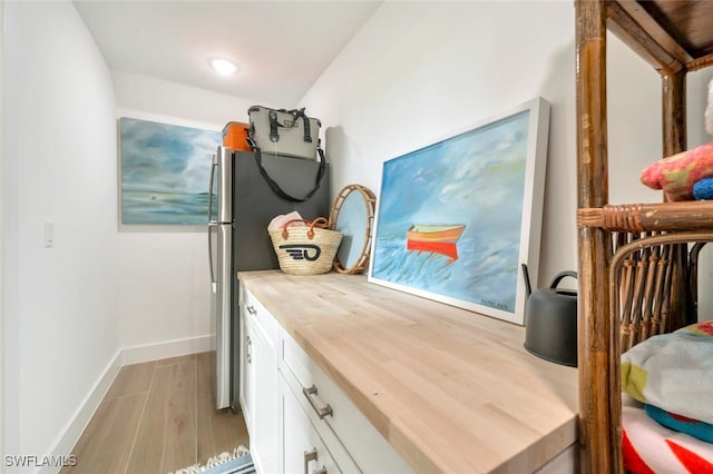 interior space featuring light hardwood / wood-style flooring, a nursery area, and stainless steel refrigerator