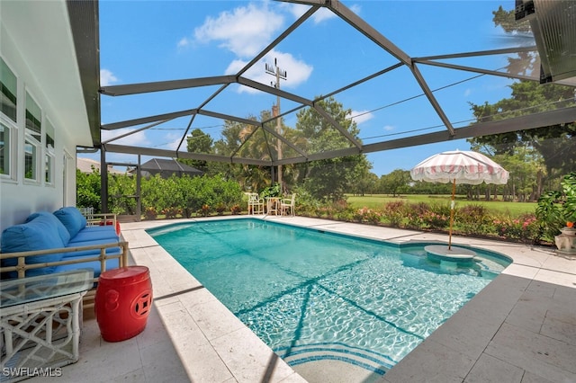 view of pool with a patio area and glass enclosure