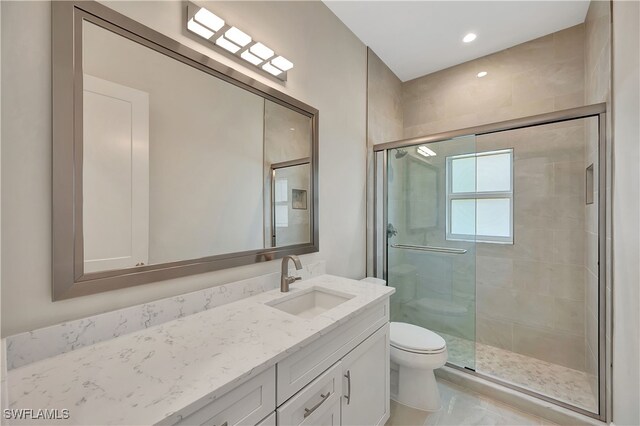 bathroom with toilet, walk in shower, and vanity