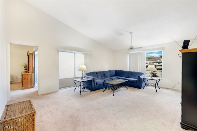 living room featuring high vaulted ceiling, light colored carpet, and ceiling fan